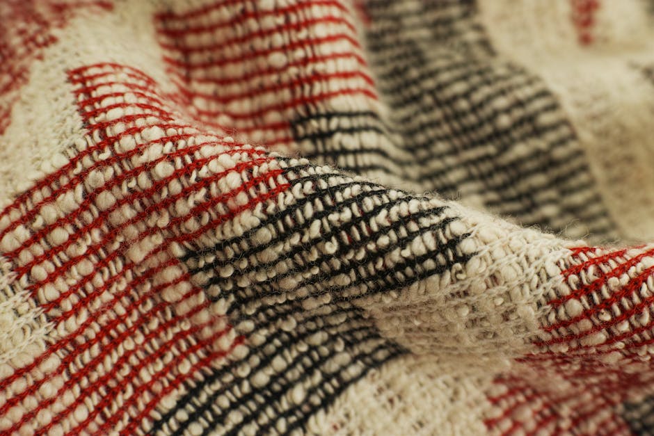 Detailed view of a red and black checked handwoven textile showcasing texture and craftsmanship.